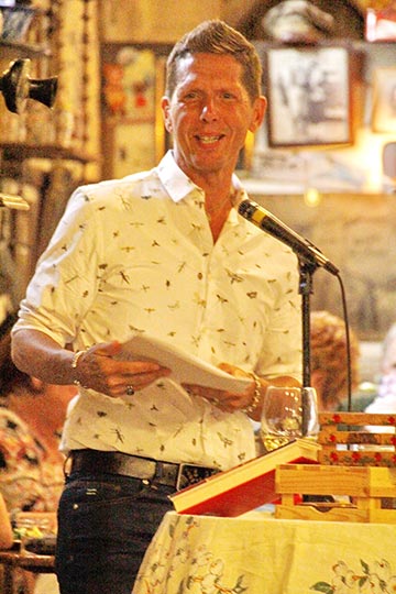 Wade Rouse/Viola Shipman speaking at a podium on tour for THE RECIPE BOX